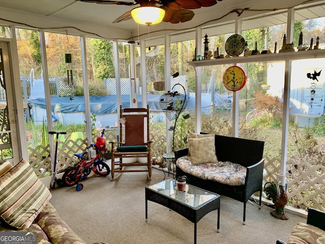 sunroom / solarium featuring ceiling fan and a healthy amount of sunlight