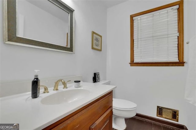 bathroom featuring tile patterned flooring, vanity, and toilet