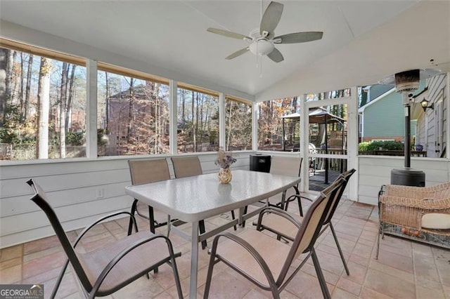 sunroom featuring ceiling fan and lofted ceiling