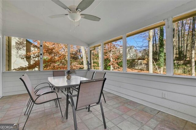 sunroom / solarium featuring ceiling fan