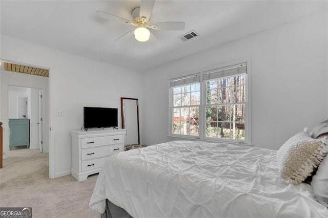 bedroom featuring light carpet and ceiling fan