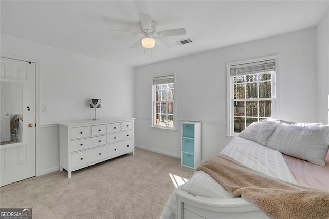 bedroom with ceiling fan and light colored carpet