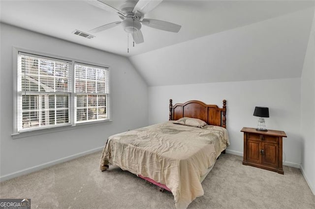 bedroom featuring ceiling fan, light colored carpet, and vaulted ceiling