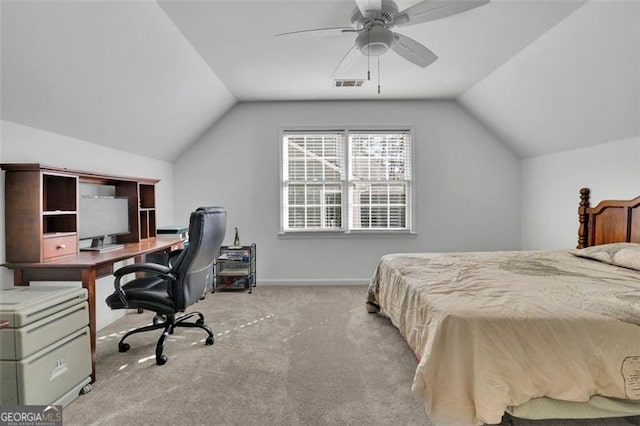 carpeted bedroom with ceiling fan and vaulted ceiling