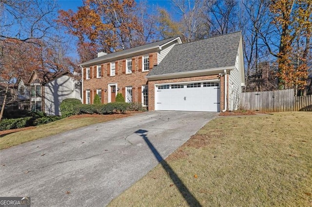 view of front of home with a garage and a front lawn