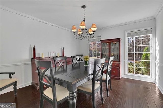 dining space with plenty of natural light, dark hardwood / wood-style flooring, and a chandelier