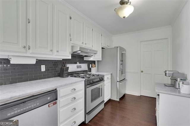 kitchen featuring white cabinets, appliances with stainless steel finishes, dark hardwood / wood-style floors, and decorative backsplash