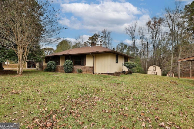 view of side of property featuring a yard and a storage shed