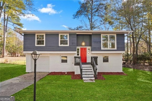 raised ranch featuring a front lawn and a garage