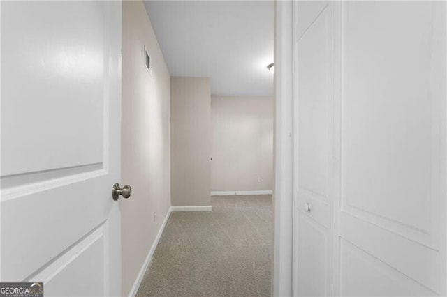 hallway with light colored carpet