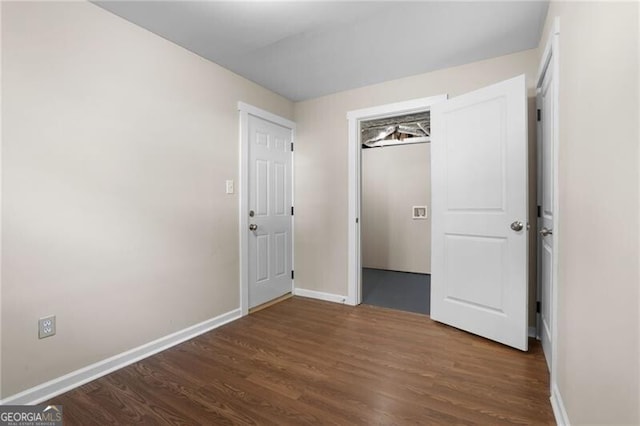 unfurnished bedroom featuring dark hardwood / wood-style flooring