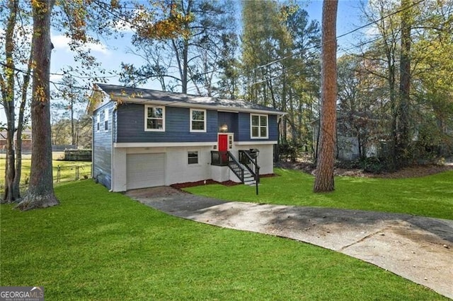 split foyer home with a garage and a front lawn