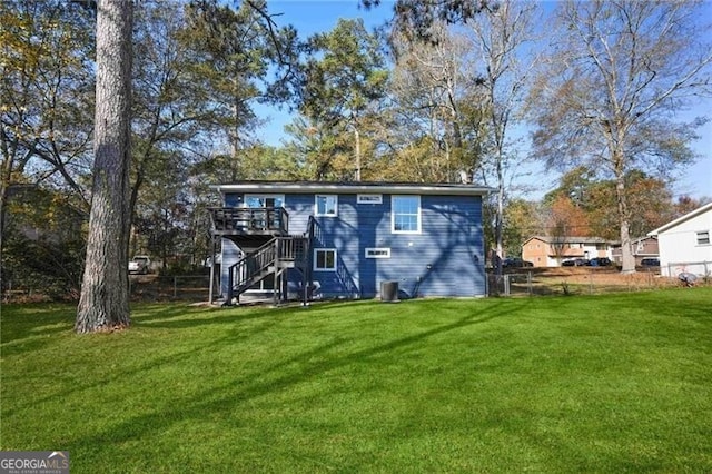 back of property featuring a lawn and a wooden deck