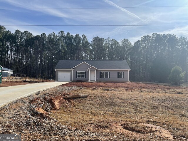 view of front of house with a front yard and a garage