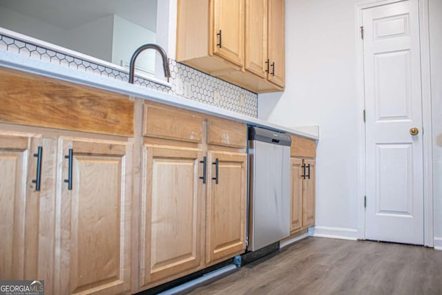 kitchen with decorative backsplash, dark hardwood / wood-style flooring, and sink