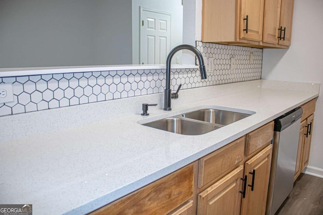 kitchen featuring light stone countertops, tasteful backsplash, sink, wood-type flooring, and dishwasher