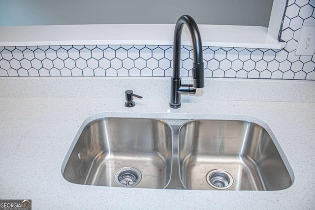 interior details featuring backsplash and sink