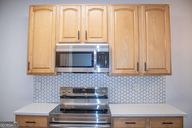 kitchen with decorative backsplash, light brown cabinets, and stainless steel appliances