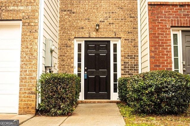 view of exterior entry featuring a garage