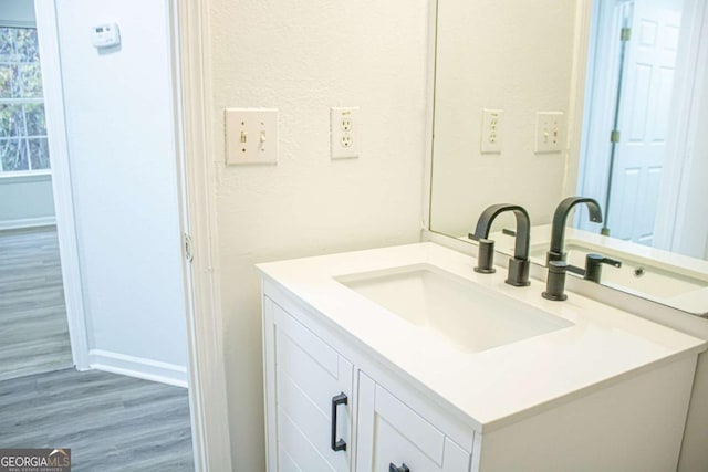 bathroom featuring hardwood / wood-style flooring and vanity