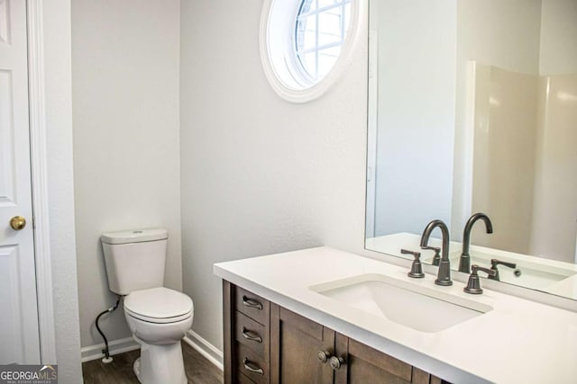 bathroom featuring hardwood / wood-style floors, vanity, and toilet