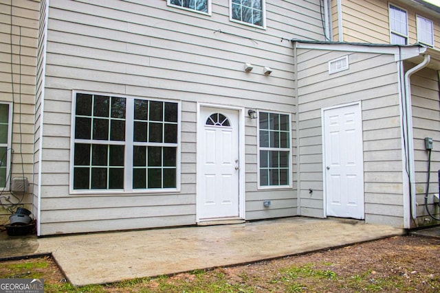 entrance to property featuring a patio area