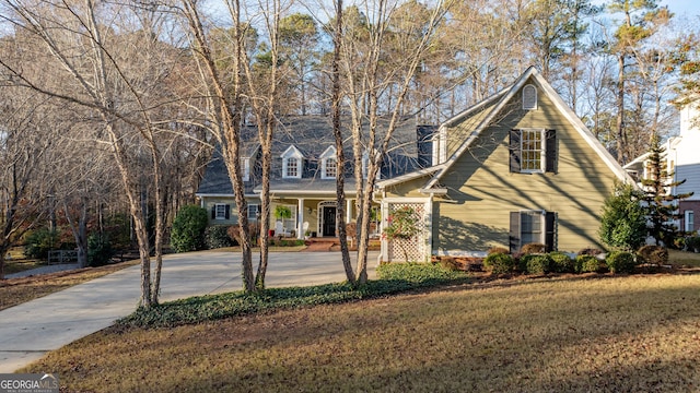 cape cod house with a front lawn