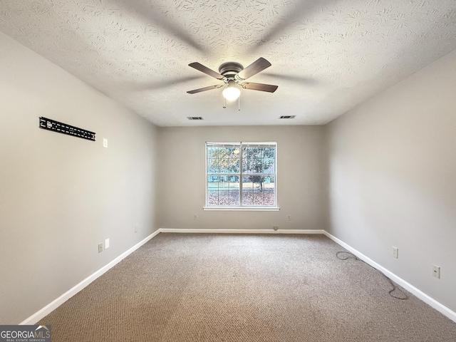 carpeted empty room featuring ceiling fan and a textured ceiling