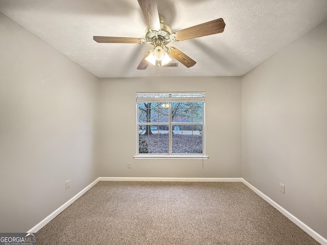 carpeted empty room featuring ceiling fan and a textured ceiling