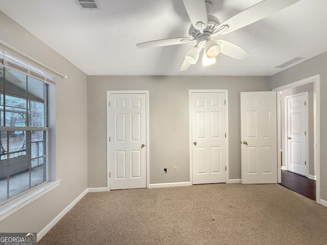 unfurnished bedroom with ceiling fan and carpet floors