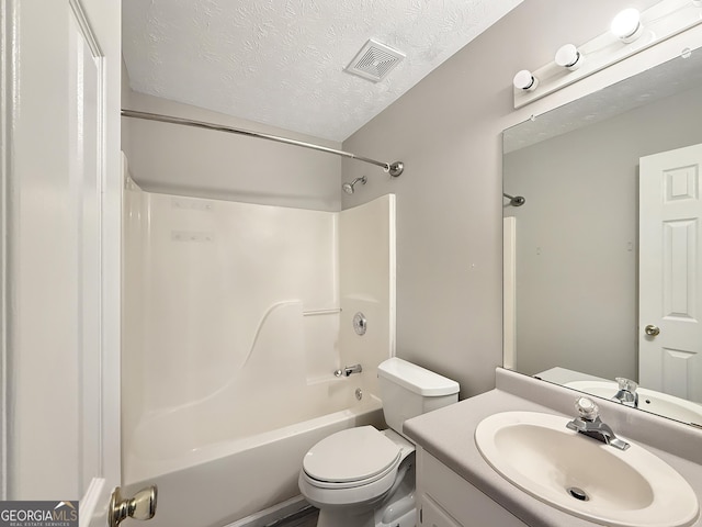 full bathroom with vanity, shower / bath combination, a textured ceiling, and toilet