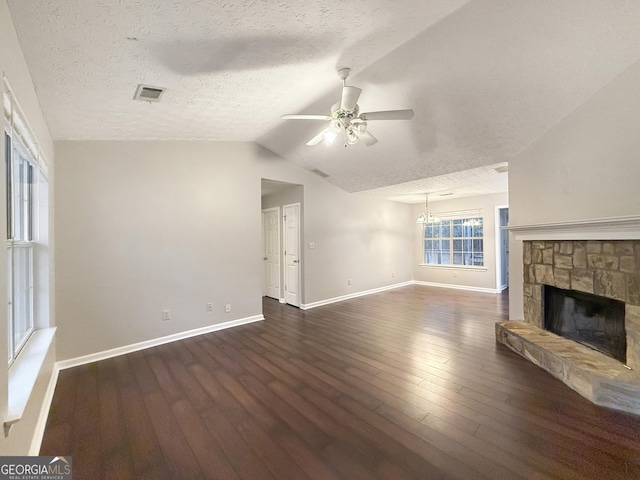 unfurnished living room with dark hardwood / wood-style floors, a textured ceiling, and vaulted ceiling