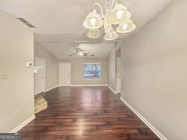 interior space featuring a textured ceiling, dark hardwood / wood-style flooring, ceiling fan with notable chandelier, and vaulted ceiling