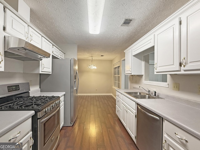 kitchen featuring dark hardwood / wood-style flooring, sink, white cabinets, and appliances with stainless steel finishes