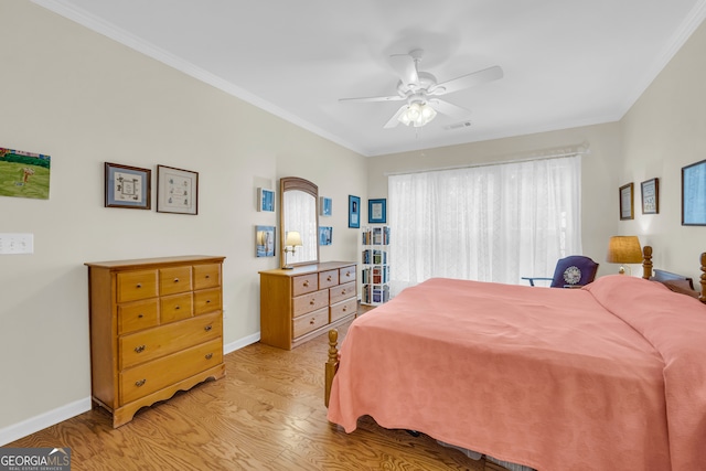 bedroom featuring light hardwood / wood-style flooring, ceiling fan, and ornamental molding