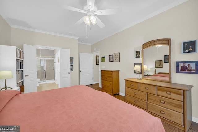 bedroom featuring hardwood / wood-style flooring, ensuite bath, ceiling fan, and ornamental molding