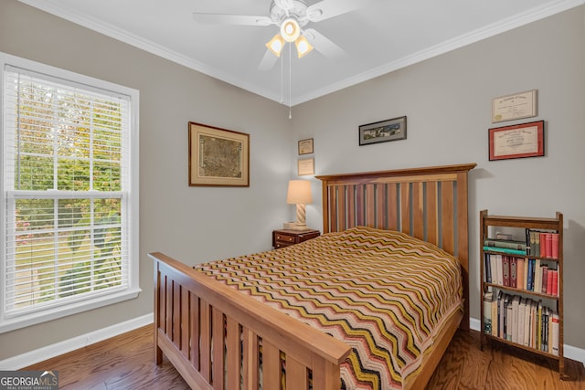 bedroom with ceiling fan, wood-type flooring, and ornamental molding