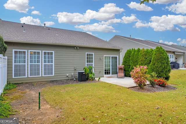 back of house with a lawn, central AC, and a patio