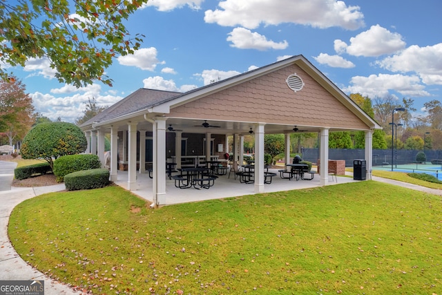 surrounding community with a lawn and a patio area