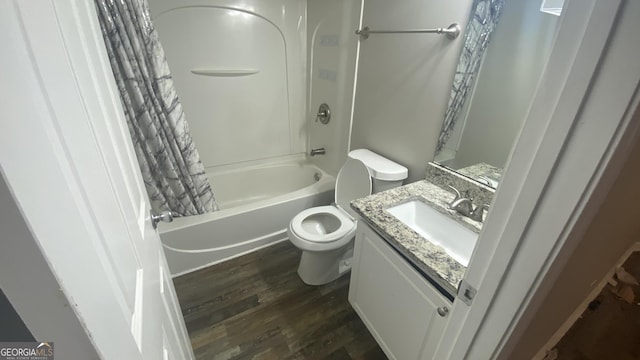 full bathroom featuring vanity, toilet, wood-type flooring, and shower / tub combo with curtain