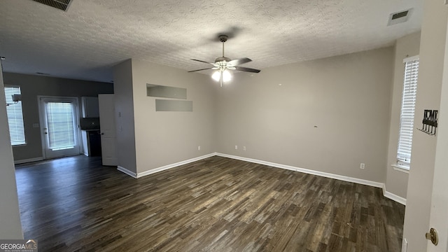 spare room featuring a textured ceiling, dark hardwood / wood-style flooring, and ceiling fan