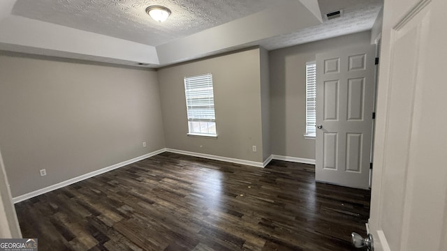 foyer entrance featuring dark hardwood / wood-style floors and a textured ceiling