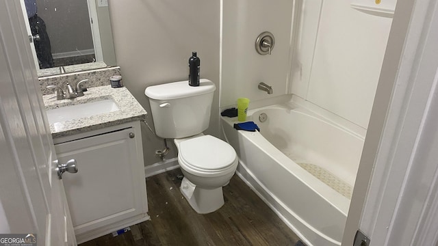 full bathroom with washtub / shower combination, toilet, vanity, and hardwood / wood-style flooring