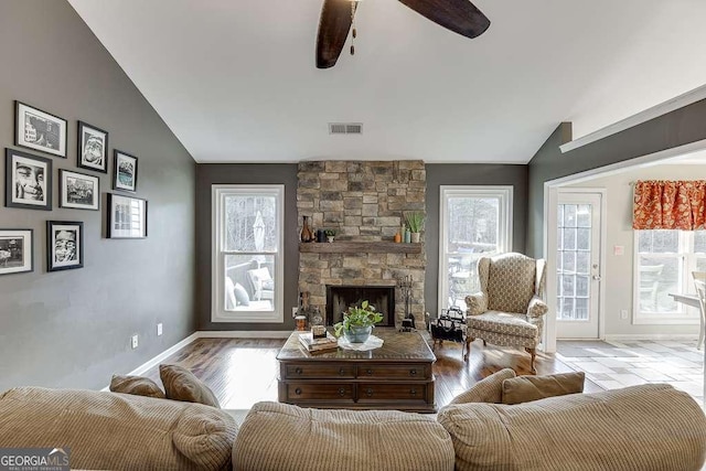 living room featuring a wealth of natural light and vaulted ceiling