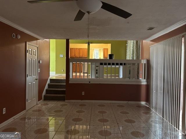 kitchen with stainless steel refrigerator, ceiling fan, crown molding, hardwood / wood-style floors, and a textured ceiling