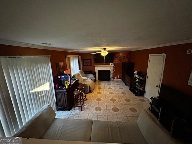 living room with light tile patterned floors, crown molding, ceiling fan, and lofted ceiling