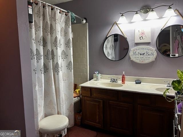 bathroom with shower / bath combination with curtain and vanity