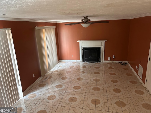 unfurnished living room featuring a textured ceiling, a fireplace, visible vents, baseboards, and ornamental molding