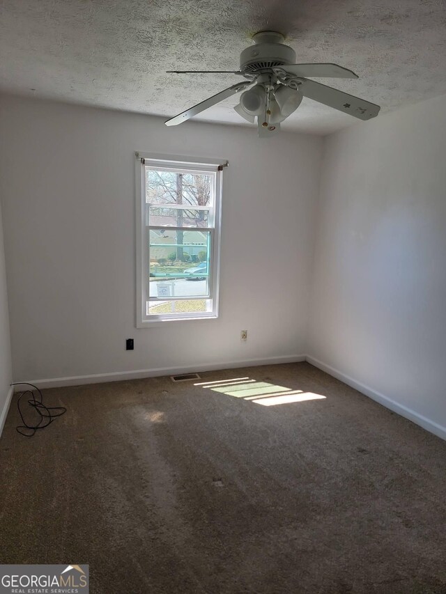 bedroom featuring dark carpet, a textured ceiling, and vaulted ceiling