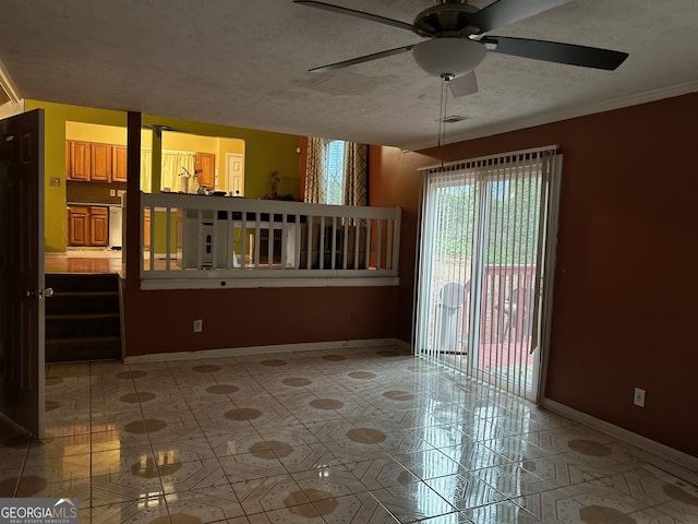 empty room with visible vents, a textured ceiling, baseboards, and light tile patterned floors